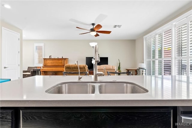 2542 E Alterna Dr, Fort Mohave, AZ 86426 - kitchen featuring light countertops, a ceiling fan, visible vents, and a sink