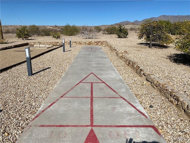 view of community featuring shuffleboard and a mountain view