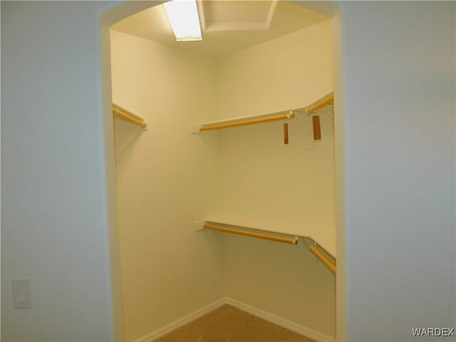 walk in closet with arched walkways