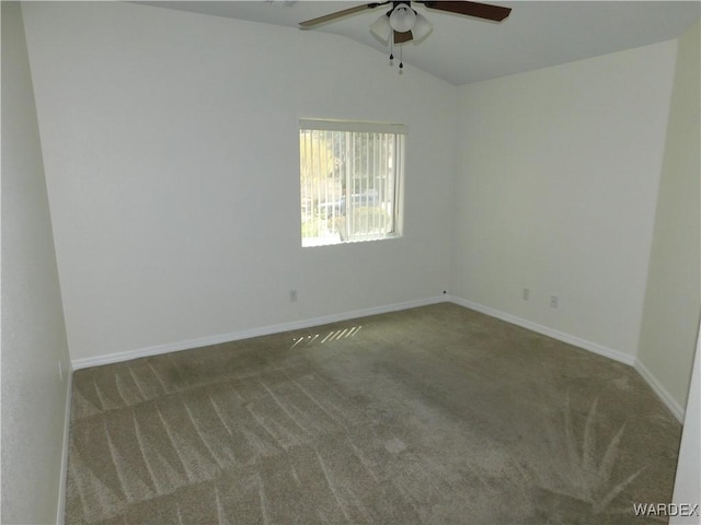 carpeted empty room with ceiling fan, vaulted ceiling, and baseboards