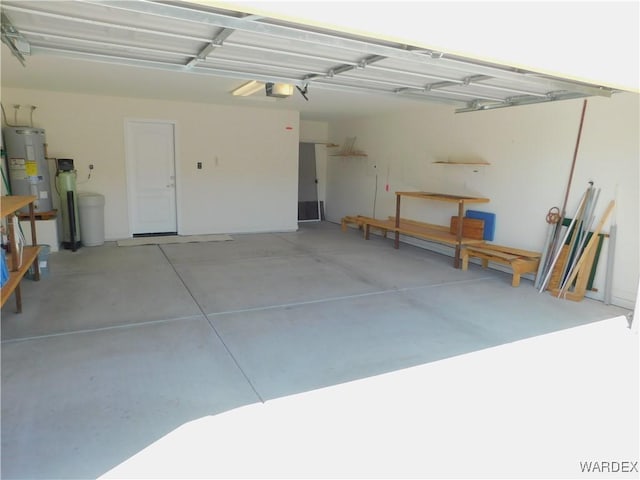 garage featuring electric water heater and a garage door opener