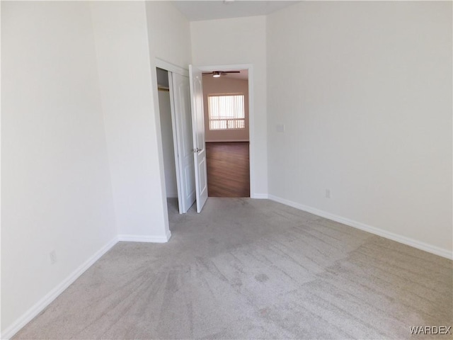spare room featuring baseboards and carpet floors