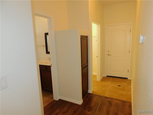 hallway with baseboards and dark wood finished floors