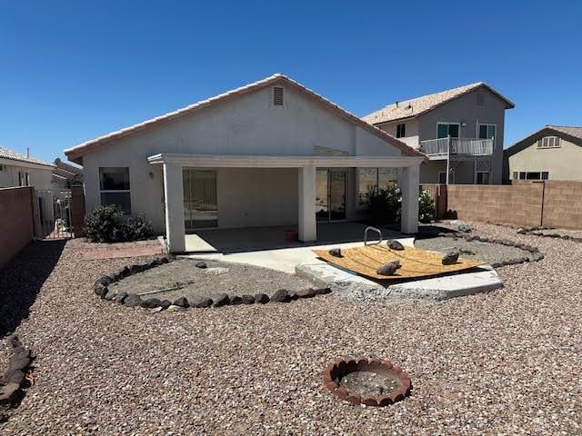 2195 Hijolly Dr, Bullhead City, AZ 86442 - rear view of house with a patio area, a fenced backyard, and stucco siding