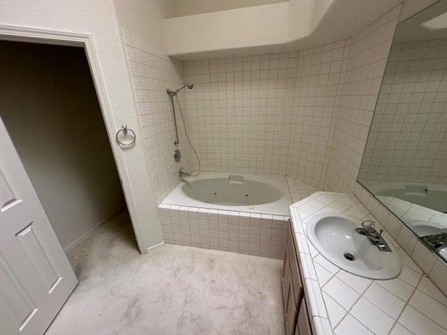 2195 Hijolly Dr, Bullhead City, AZ 86442 - full bathroom with vanity and a combined bath / shower with jetted tub