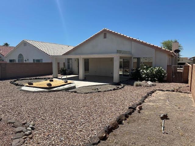 2195 Hijolly Dr, Bullhead City, AZ 86442 - back of house featuring a patio area, a tile roof, and stucco siding