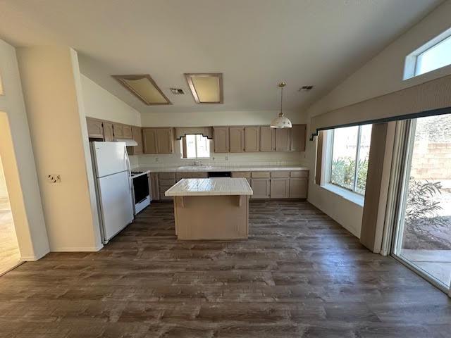 2195 Hijolly Dr, Bullhead City, AZ 86442 - kitchen featuring white appliances, a center island, plenty of natural light, dark wood-style floors, and high vaulted ceiling