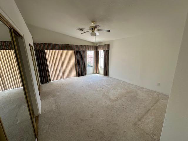 2195 Hijolly Dr, Bullhead City, AZ 86442 - carpeted empty room with a ceiling fan and lofted ceiling