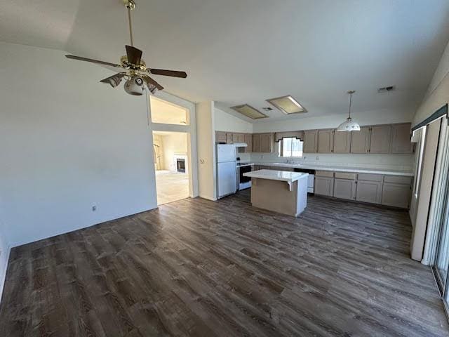 2195 Hijolly Dr, Bullhead City, AZ 86442 - kitchen with lofted ceiling, stainless steel appliances, dark wood-type flooring, light countertops, and open floor plan