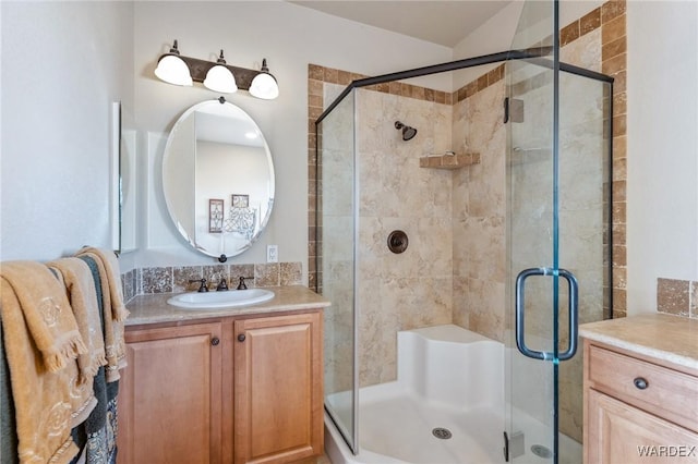 bathroom with a stall shower and vanity