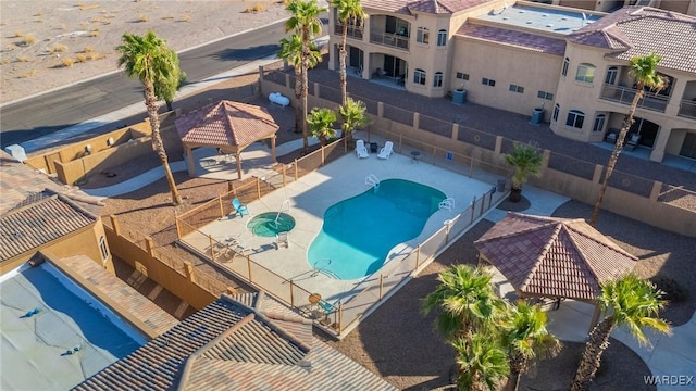 community pool featuring a patio area and fence