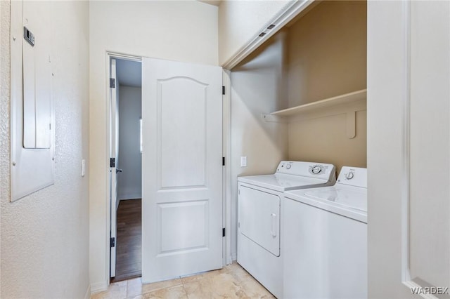 washroom featuring washer and dryer, laundry area, and electric panel