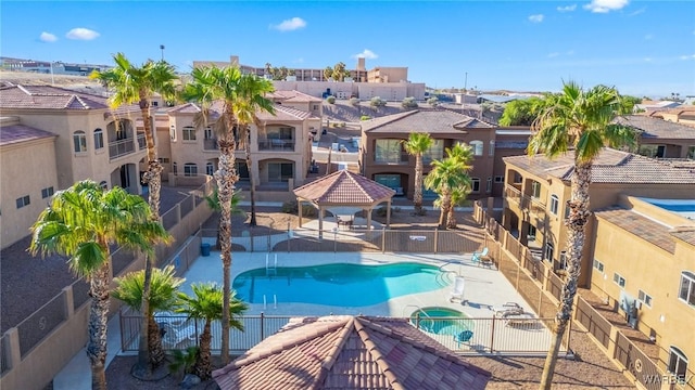 community pool featuring a patio area, a gazebo, a community hot tub, and fence