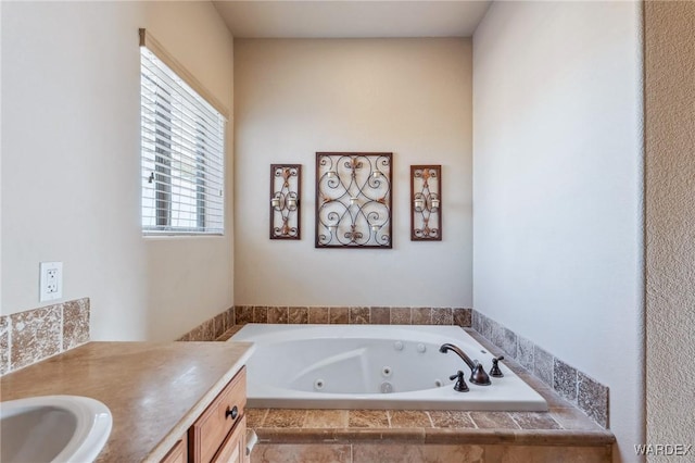 full bath with a whirlpool tub and vanity