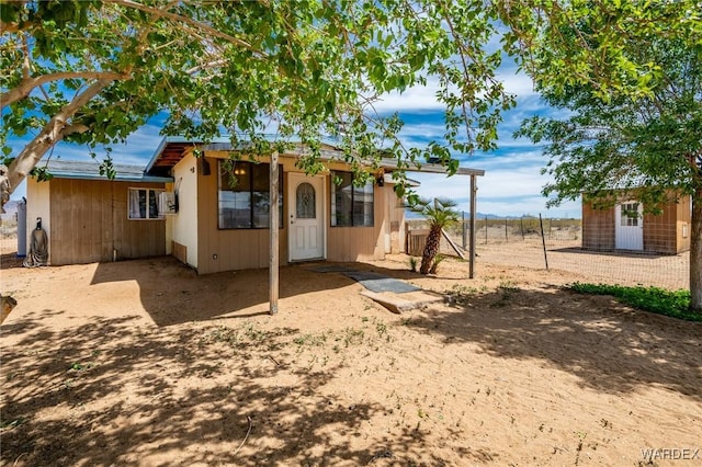 exterior space featuring fence and an outdoor structure