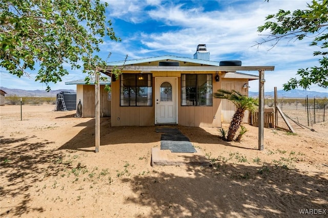 exterior space featuring a chimney and fence