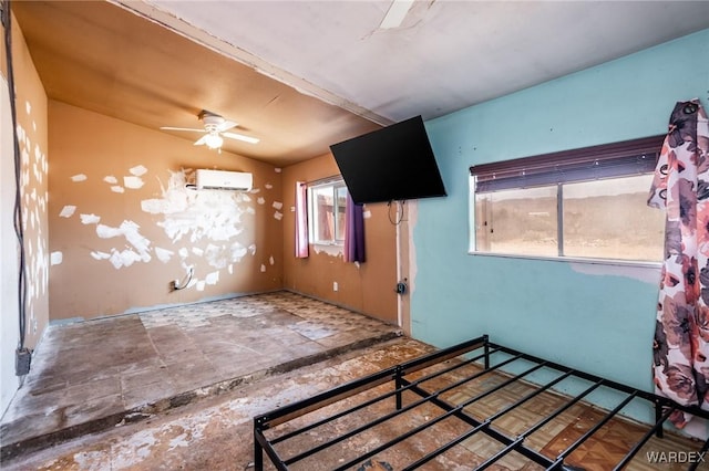 spare room featuring a ceiling fan and a wall mounted AC