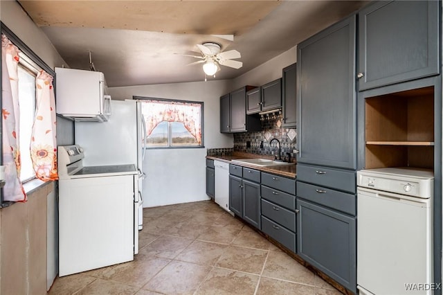 kitchen with a sink, backsplash, white appliances, ceiling fan, and light tile patterned floors