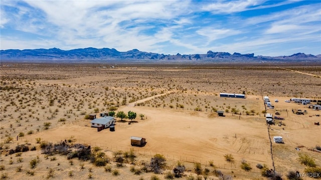 birds eye view of property featuring a mountain view, a desert view, and a rural view