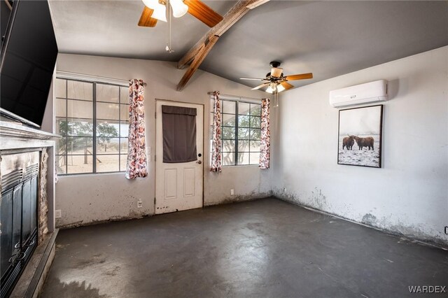 empty room with a wall mounted air conditioner, a ceiling fan, vaulted ceiling with beams, concrete flooring, and a glass covered fireplace