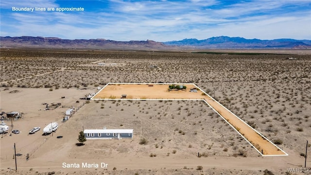 birds eye view of property featuring a rural view, a desert view, and a mountain view