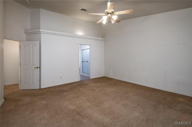 unfurnished room featuring visible vents, carpet floors, a high ceiling, and a ceiling fan