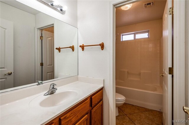 bathroom with tile patterned flooring, toilet, vanity, visible vents, and  shower combination