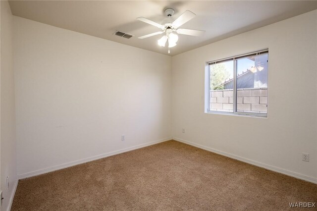 empty room featuring baseboards, visible vents, ceiling fan, and carpet flooring