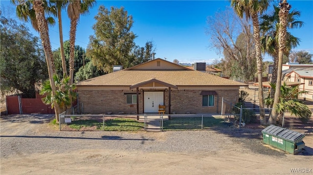 view of front of home with brick siding and a fenced front yard