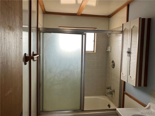 full bath featuring combined bath / shower with glass door