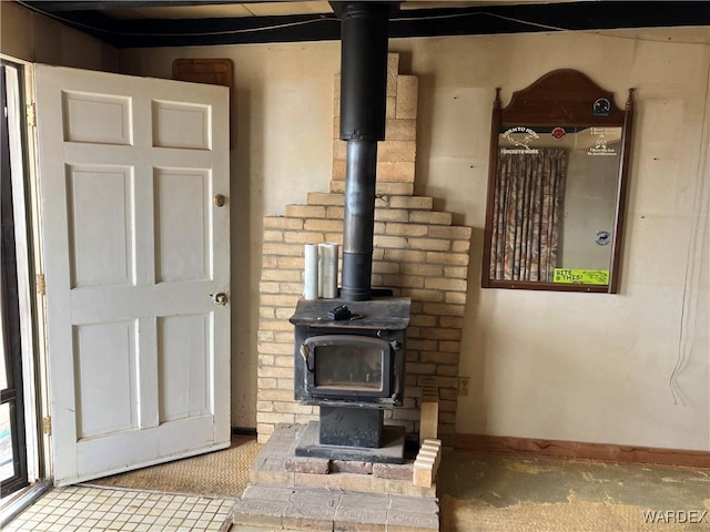 room details with a wood stove and baseboards