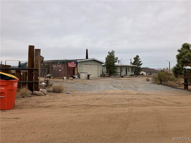 view of yard featuring an attached garage and driveway