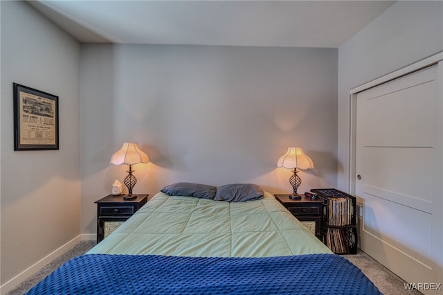 carpeted bedroom featuring baseboards