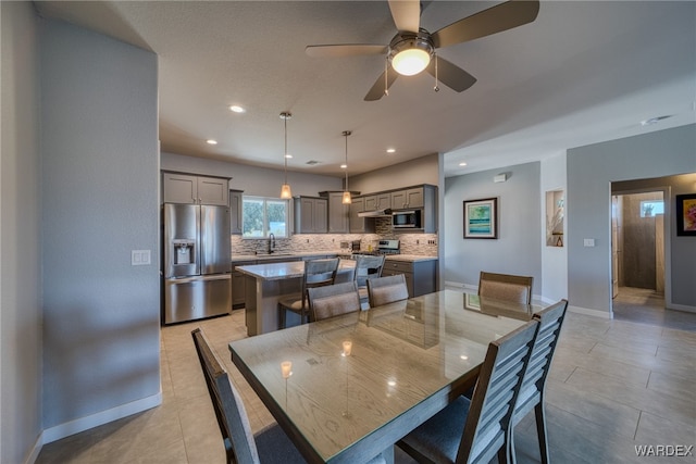 dining area featuring light tile patterned floors, baseboards, ceiling fan, and recessed lighting