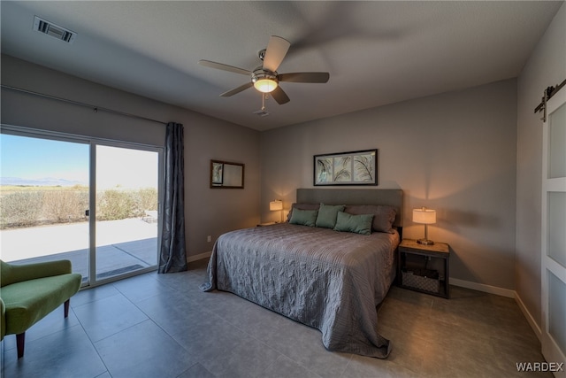 bedroom with visible vents, baseboards, a barn door, and access to outside