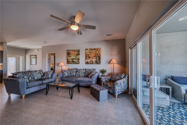 tiled living area featuring visible vents and ceiling fan