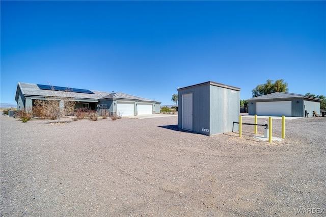 exterior space with an outbuilding and solar panels