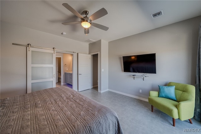 bedroom featuring visible vents, a ceiling fan, a barn door, connected bathroom, and baseboards