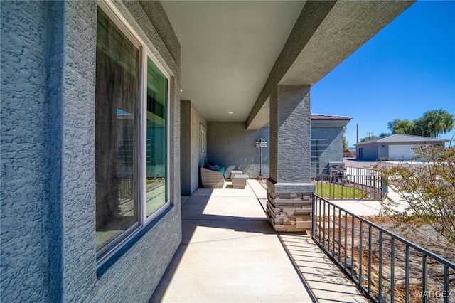 view of patio featuring a balcony