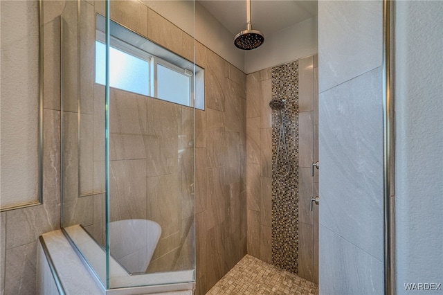 full bath featuring a tile shower