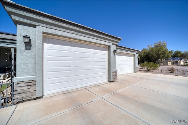 garage featuring concrete driveway