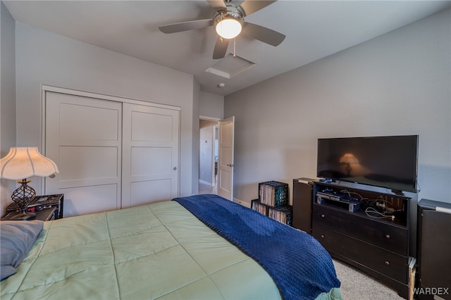 carpeted bedroom featuring a closet and ceiling fan