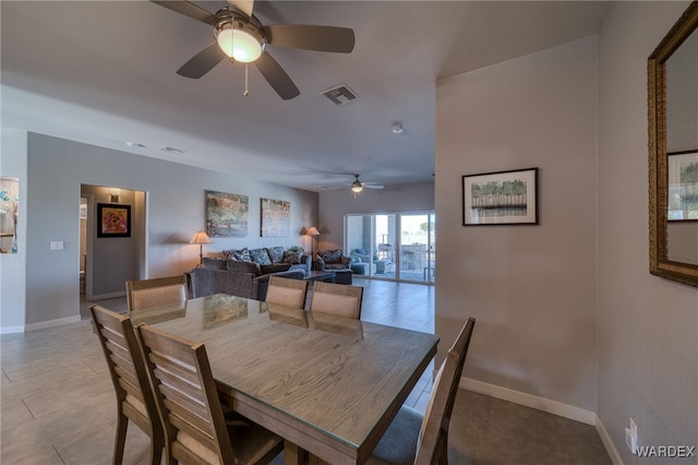 dining area featuring visible vents, a ceiling fan, and baseboards