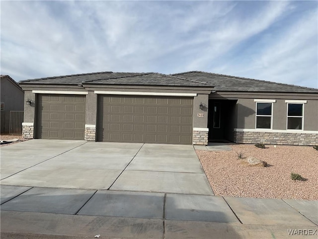 view of front of property with a garage, stone siding, driveway, and stucco siding