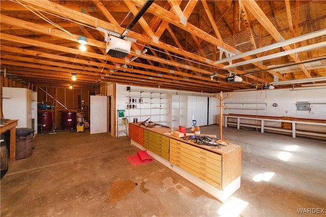 garage with electric panel and a garage door opener