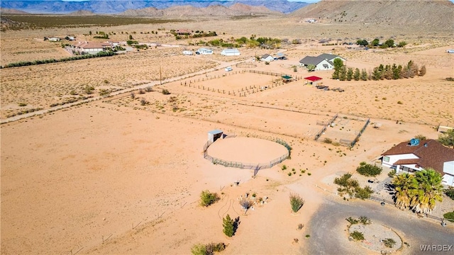 birds eye view of property featuring a rural view, view of desert, and a mountain view