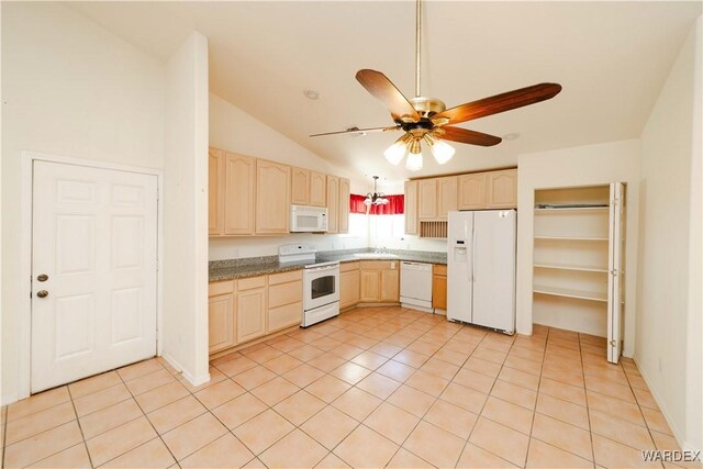 kitchen featuring lofted ceiling, light brown cabinetry, a ceiling fan, a sink, and white appliances