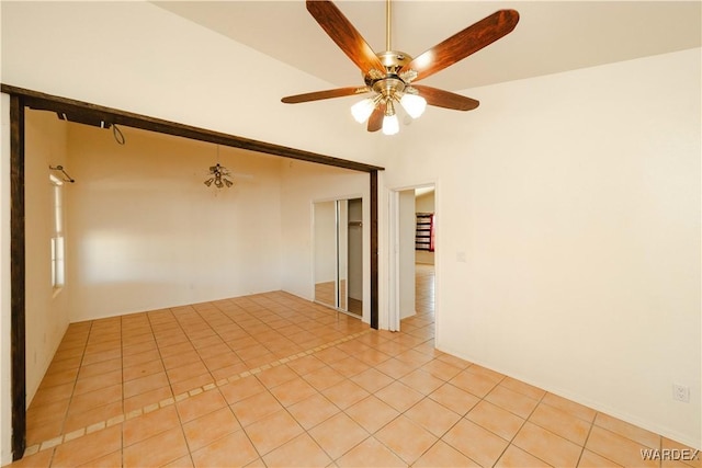 empty room featuring a ceiling fan and light tile patterned floors