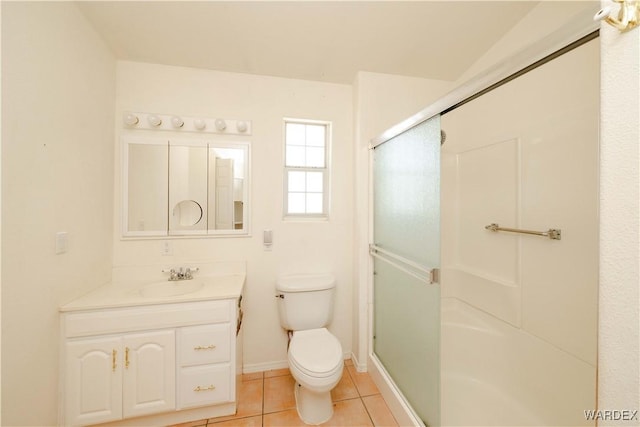 bathroom with tile patterned flooring, vanity, an enclosed shower, and toilet