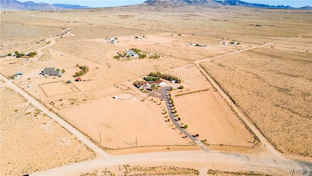 birds eye view of property featuring a rural view, view of desert, and a mountain view